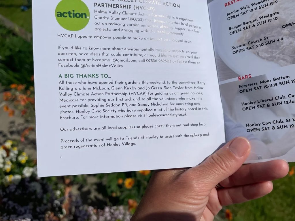 Sophie of Sophie Seddon PR holding the brochure for Honley Open Gardens where she is mentioned for supporting the event.