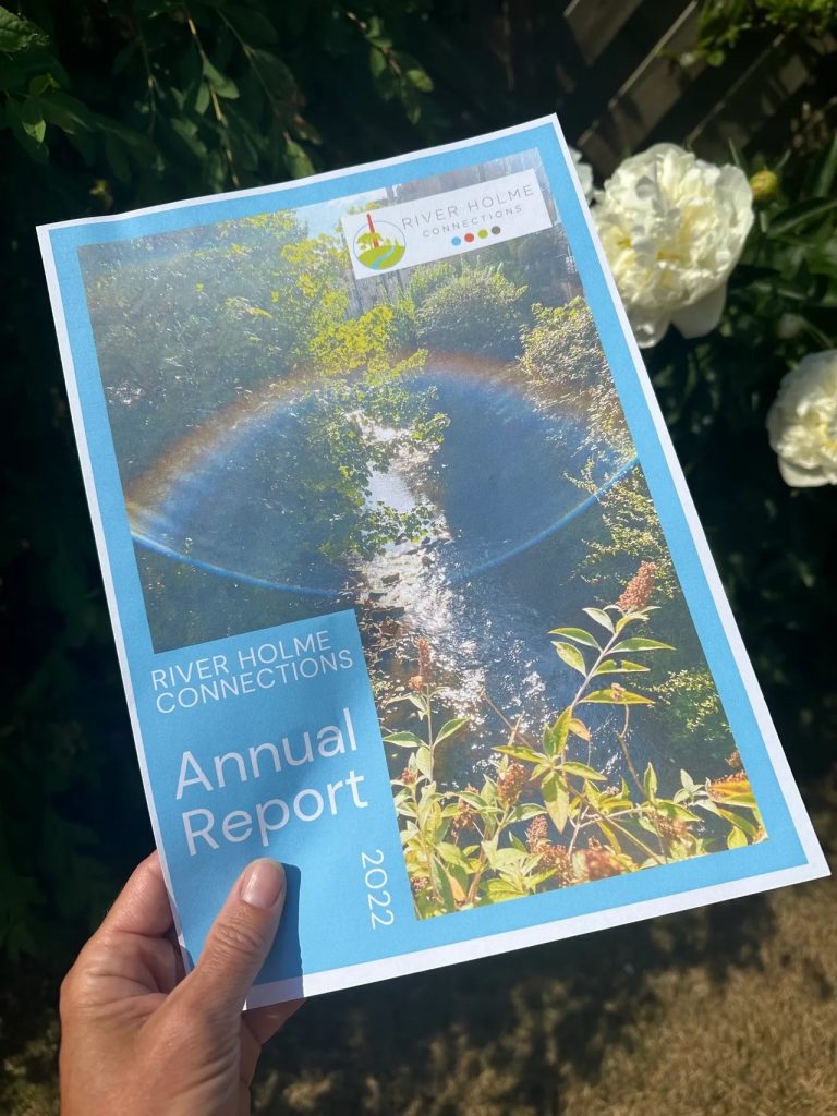 Sophie of Sophie Seddon PR holding a copy of the River Holme Connections Annual Report 2023.