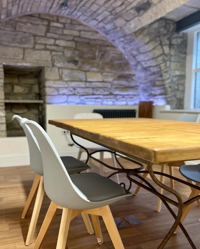 Picture of a desk and table with LED lighting in the meeting room at The Highfields Suite Honley.