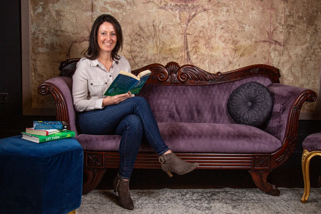 Sophie Seddon sitting on a sofa with an open notebook